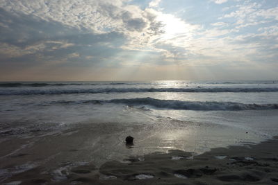 View of calm sea against cloudy sky