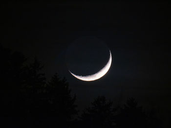 Low angle view of moon against sky at night