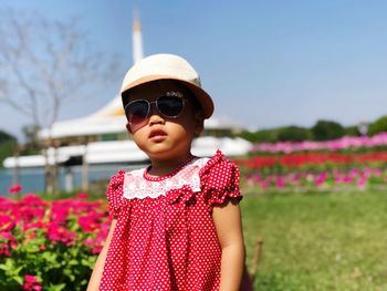 Girl wearing sunglasses while standing on field