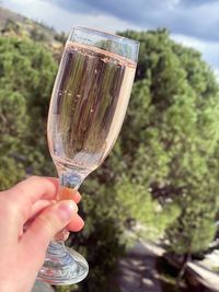 Close-up of hand holding glass bottle