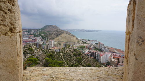 Panoramic view of sea and buildings against sky