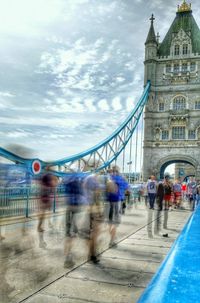 People walking on bridge in city