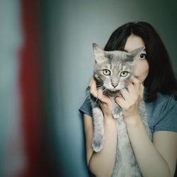 Portrait of woman holding cat