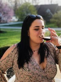 Beautiful woman drinking wine in glass