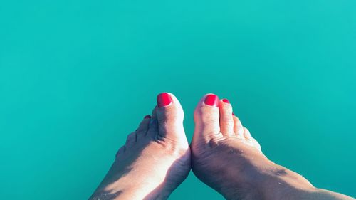 Low section of woman feet against blue background / vacation again 