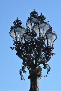 Low angle view of trees against clear blue sky