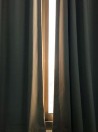 Close-up of curtain against window at home