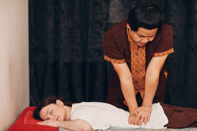 Man massaging woman at spa