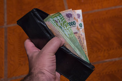 Close-up of hand holding paper