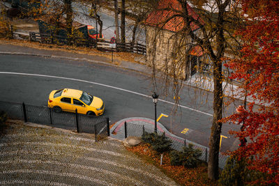 High angle view of yellow taxi on autumn street