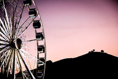 Low angle view of ferris wheel against sky