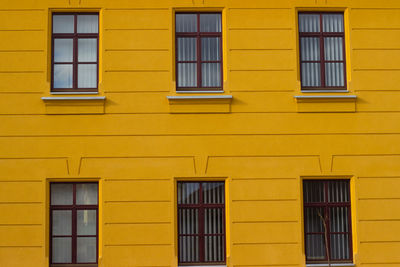 Low angle view of yellow windows on building