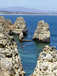 Panoramic view of sea and rocks against sky