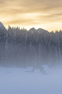 Scenic view of snow field against sky during sunset