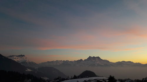 Scenic view of silhouette mountains against sky during sunset