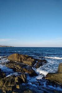 Scenic view of sea against clear blue sky