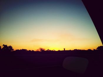 Cars on road at sunset