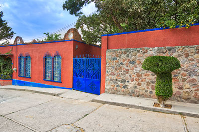 Graffiti on wall by street and trees against building