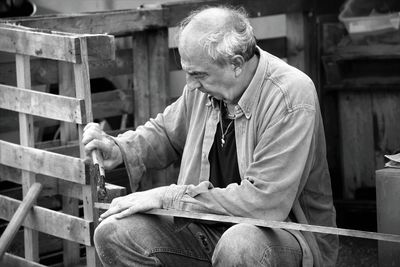 Man using pliers to repair wood 