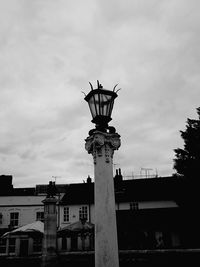 Low angle view of statue in city against sky