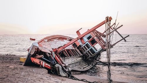 Boat on beach against sky