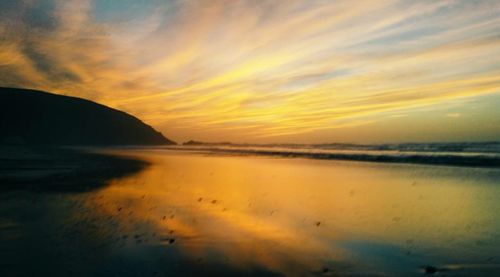 Scenic view of landscape against orange sky