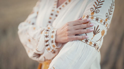 Midsection of woman holding hands