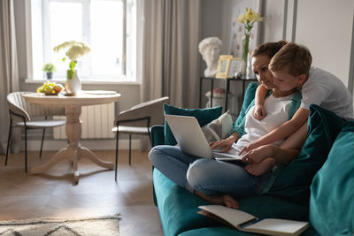 Son helping mother with work