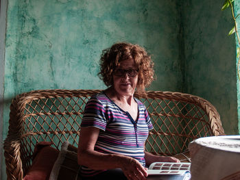 Portrait of smiling woman sitting on chair