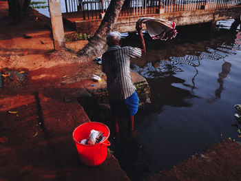 Rear view of woman standing in water