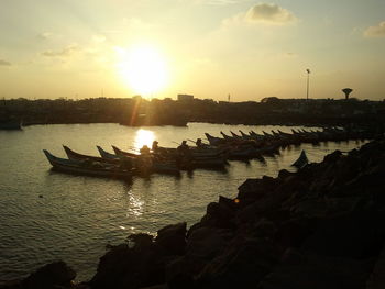 Boat in sea at sunset