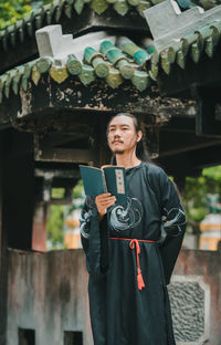 Portrait of smiling young woman standing outdoors