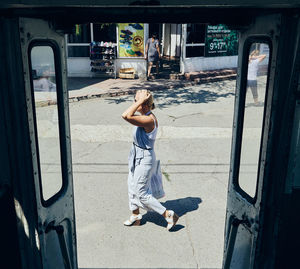 Full length of woman on bus in city