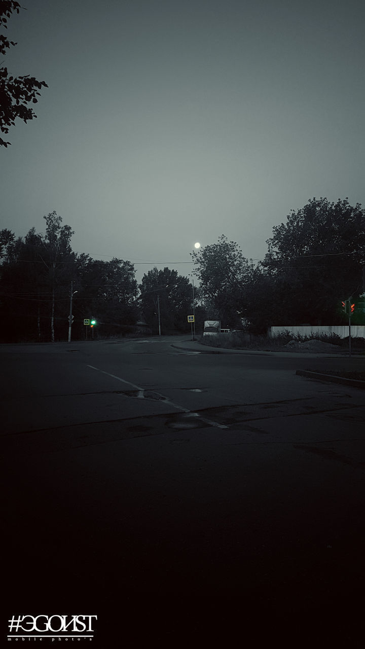 EMPTY ROAD BY TREES AGAINST CLEAR SKY