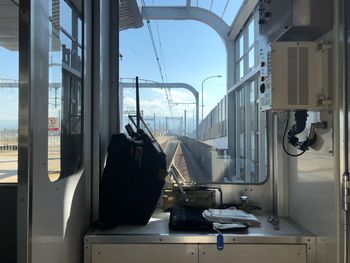 Train against sky seen through glass window