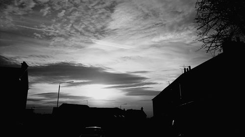 Low angle view of buildings against sky at sunset