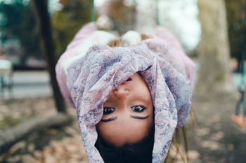 Portrait of shocked girl leaning in forest