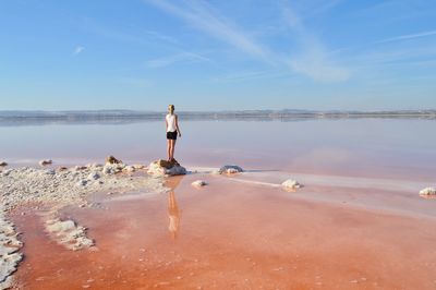 Woman on beach against sky