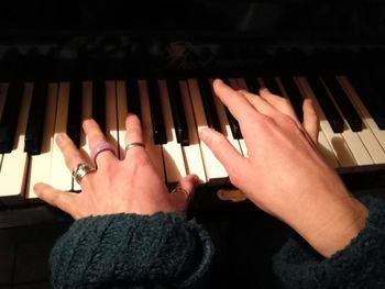 Close-up of hands playing piano