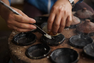 Midsection of person preparing food