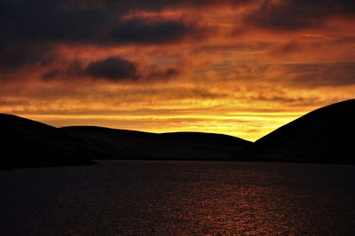 Scenic view of silhouette mountains against sky during sunset