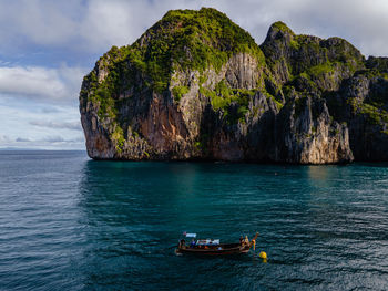 Boat sailing in sea against sky