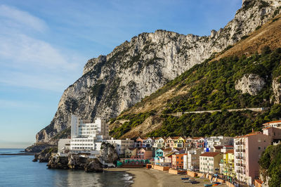 Gibraltar's catalan bay with caleta hotel and colorful residential houses