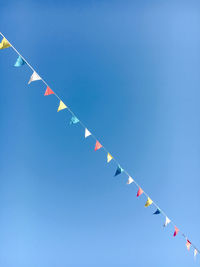 Low angle view of airshow against clear blue sky