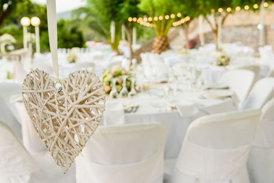 Close-up of heart shape against chairs at wedding ceremony