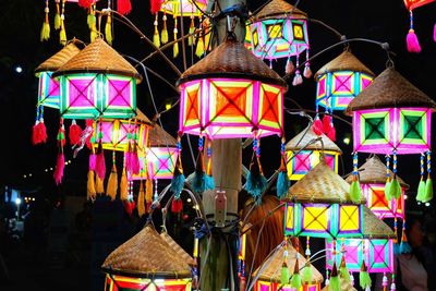 Multi colored umbrellas hanging for sale at market stall