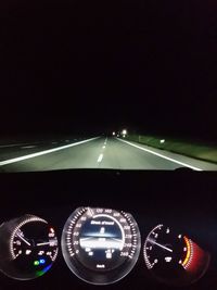 Close-up of illuminated car against clear sky at night