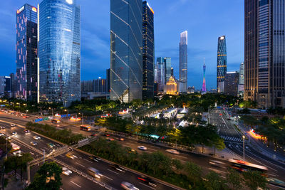 Aerial view of city street and buildings against sky