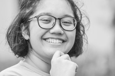 Close-up portrait of smiling young woman