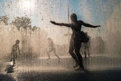 Silhouette of man standing in water